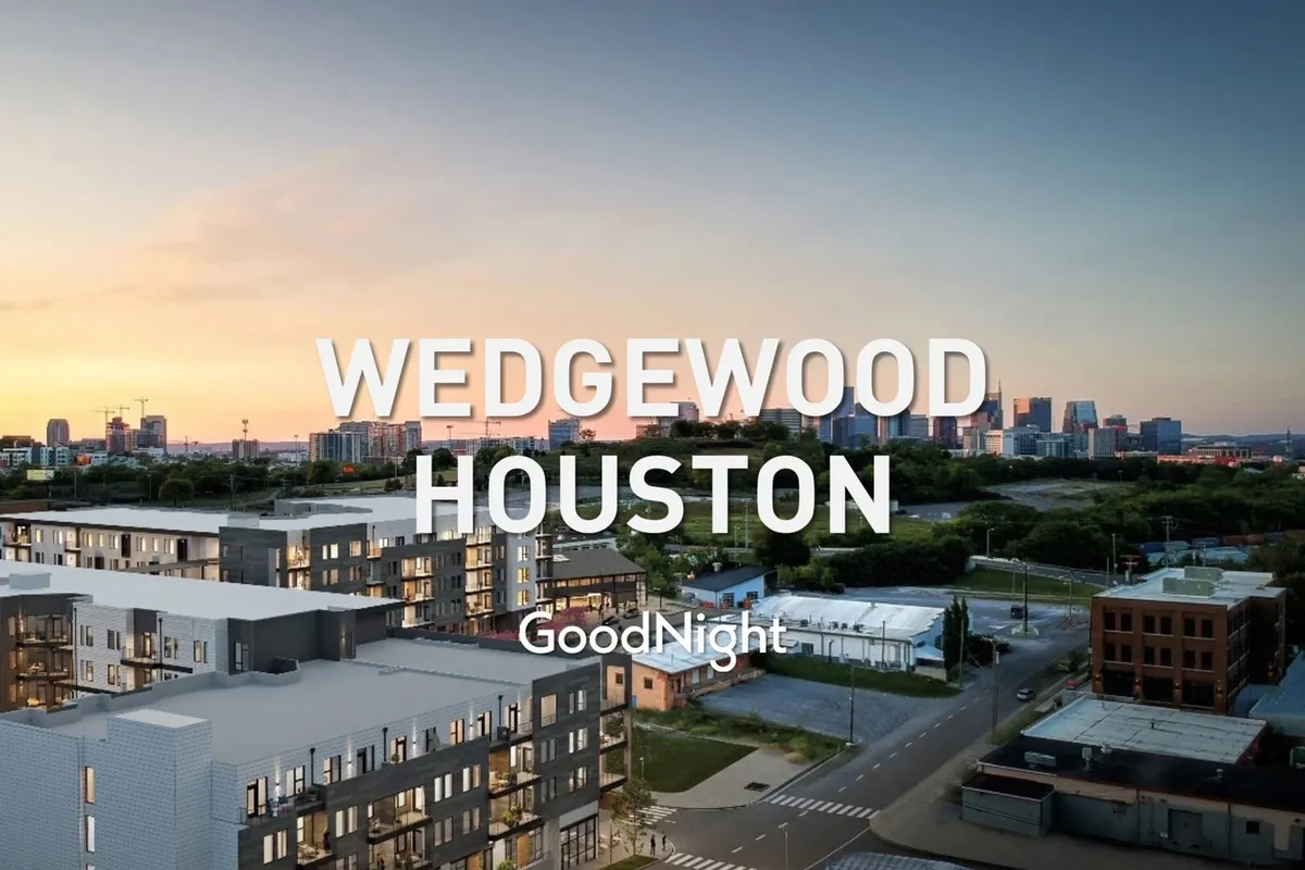 A sunset scene featuring modern apartment buildings and the Nashville city skyline, bathed in warm evening light. The mood is serene and welcoming, emphasizing urban living and offering a glimpse of relaxation at day's end.