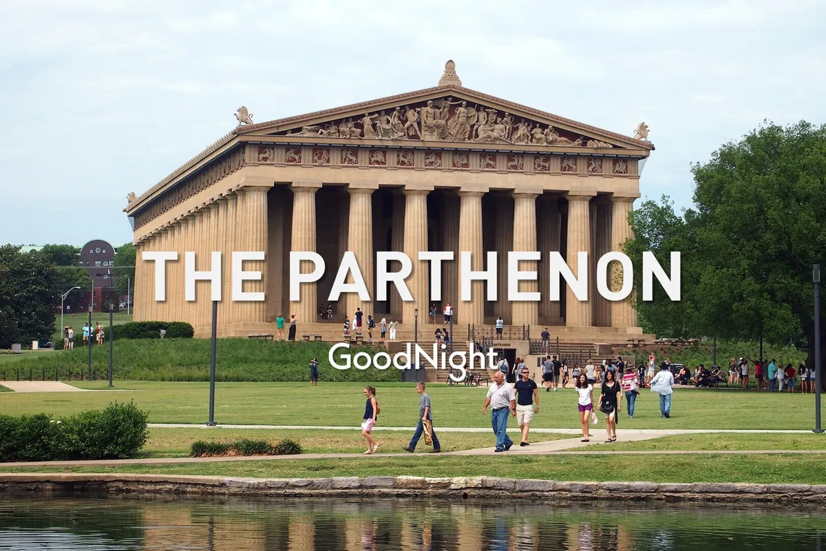 The photo features the Parthenon structure at Centennial Park, with visitors walking across lush green grass. The scene is joyful and relaxed, showing people sightseeing, taking photos, and enjoying the outdoors.