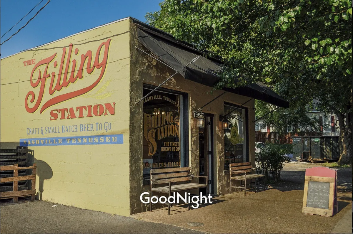 The Filling Station’s recognizable sign anchors this friendly exterior shot, with a display of craft beers and an outdoor seating area where friends are gathered. The mood is relaxed yet social, perfect for a casual evening out.