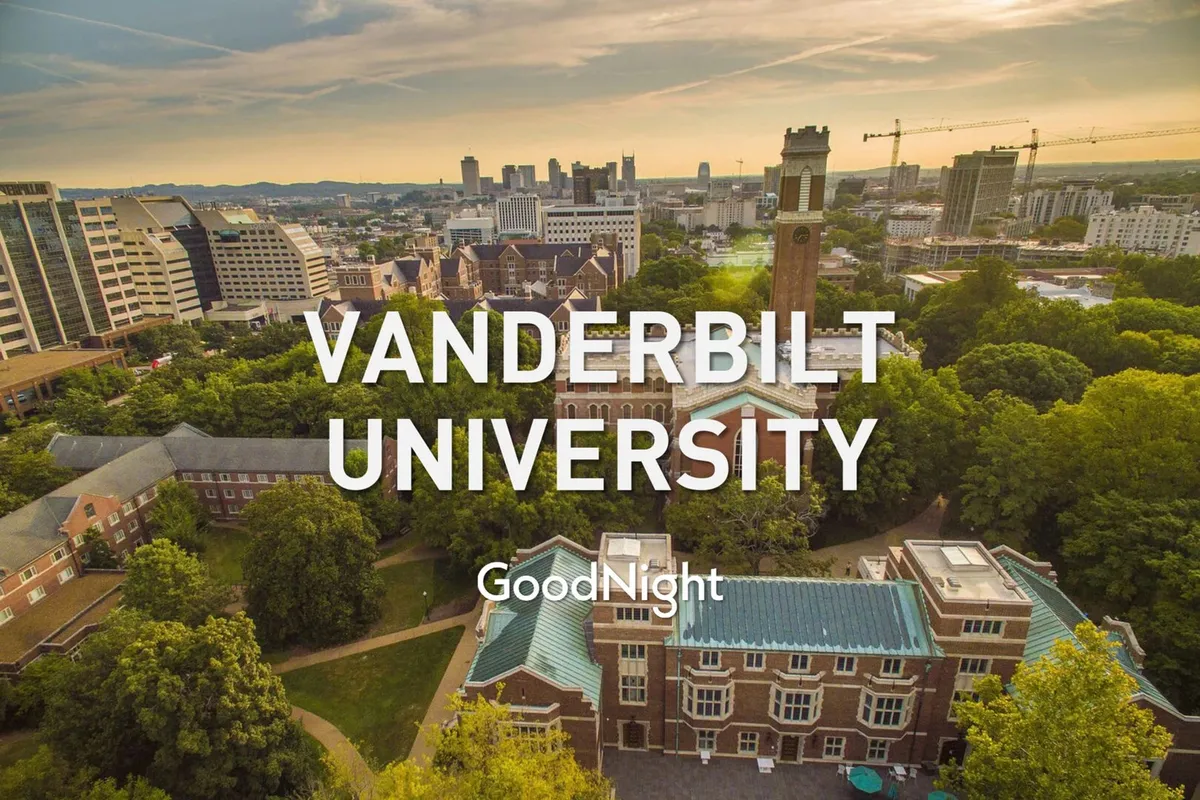 A sweeping view of Vanderbilt University’s iconic clock tower rising above lush campus greenery with the city skyline in the background. The scene is bright and inspirational, giving a sense of the university’s prominence in the local landscape.