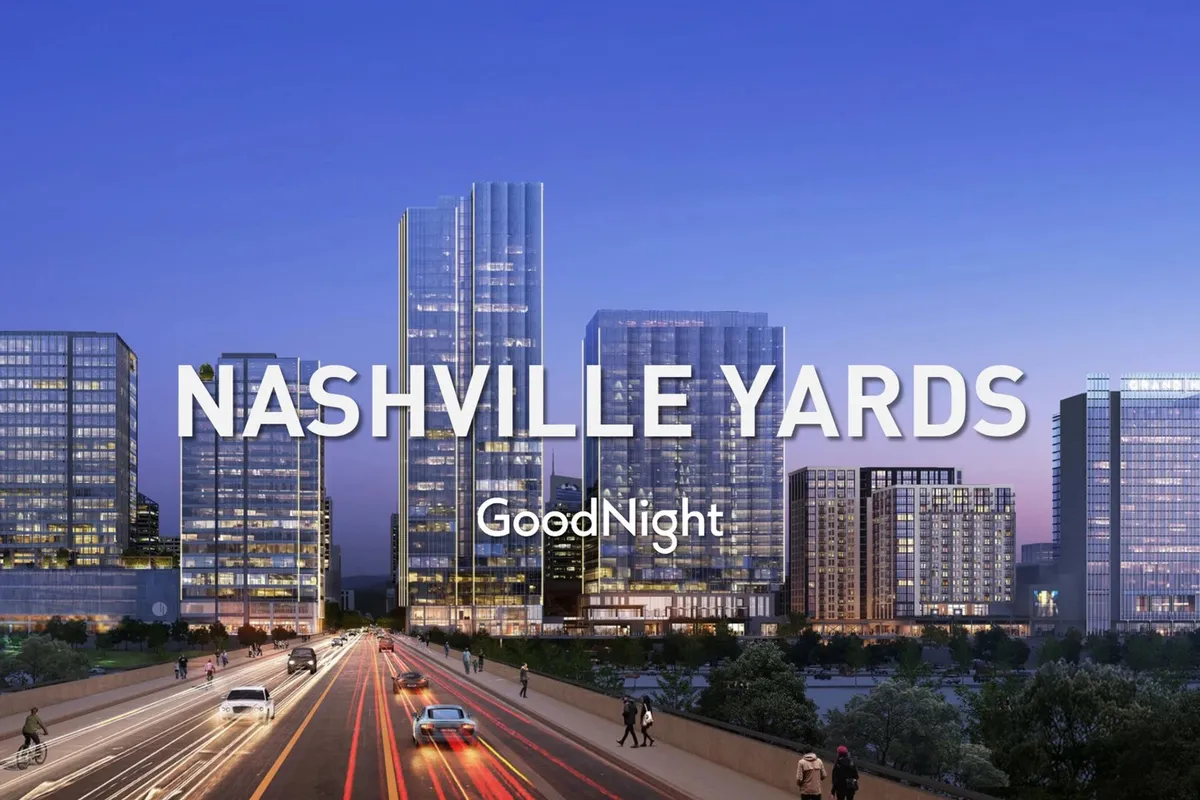 A sweeping view of Nashville's cityscape at dusk, with illuminated skyscrapers and a lively roadway below. The image captures the dynamic atmosphere of urban life and offers a visual of the vistas available from the rooftop.